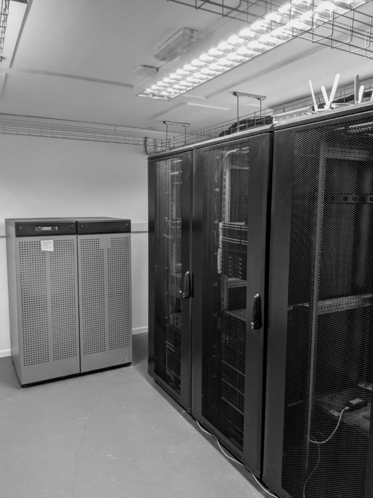 Original 101 Data Solutions server room featuring server racks, APC UPS power protection and structured network cabling.